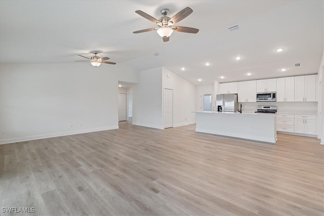 unfurnished living room featuring ceiling fan, lofted ceiling, and light hardwood / wood-style floors