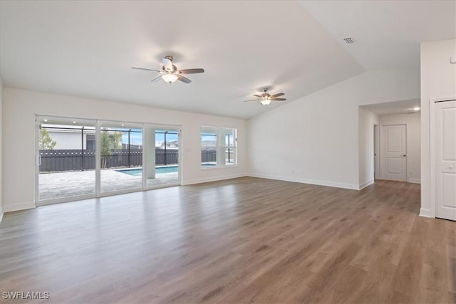 unfurnished living room featuring hardwood / wood-style flooring, ceiling fan, and lofted ceiling