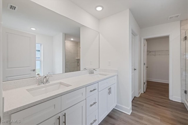 bathroom featuring vanity, hardwood / wood-style floors, and a shower with shower door