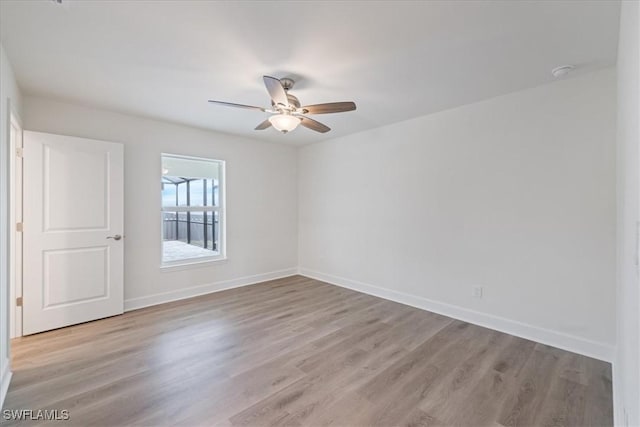 empty room with ceiling fan and light wood-type flooring