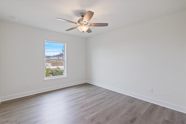 empty room with hardwood / wood-style flooring and ceiling fan