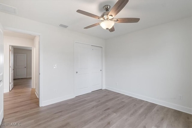 unfurnished bedroom with a closet, ceiling fan, and light hardwood / wood-style flooring