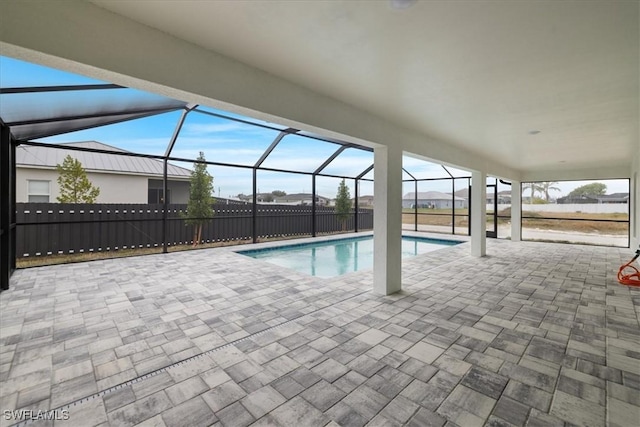 view of pool with a patio and glass enclosure