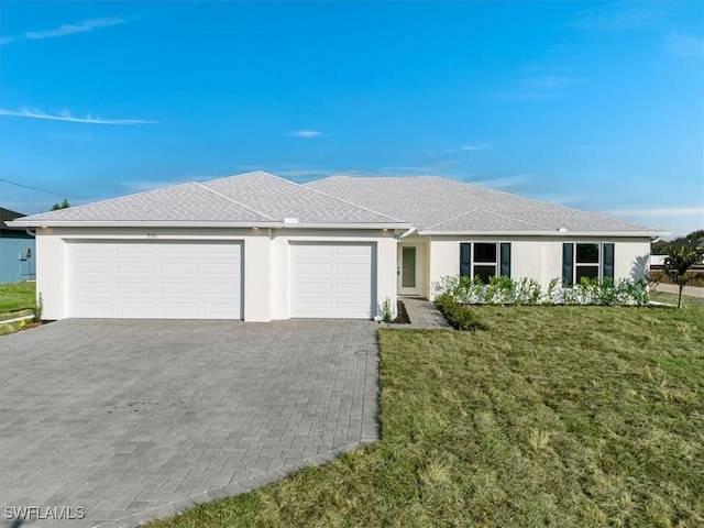 ranch-style home with a garage and a front yard