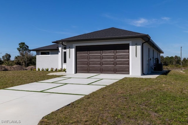 view of front of home with central AC unit, a garage, and a front yard