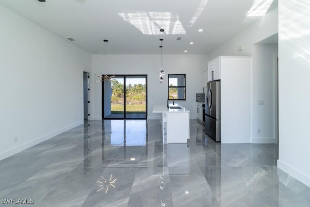 interior space with ceiling fan and sink