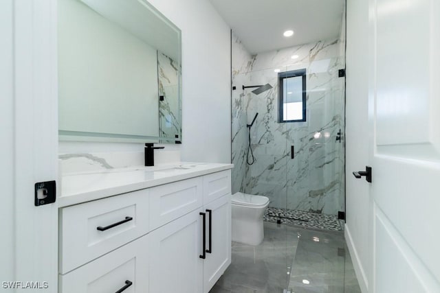 bathroom with a shower with door, vanity, and toilet