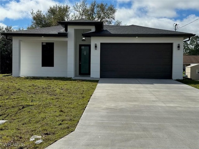 view of front of house featuring a garage and a front lawn