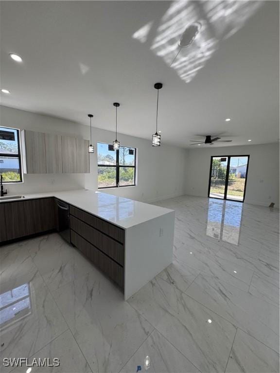 kitchen with open floor plan, light countertops, a peninsula, marble finish floor, and modern cabinets