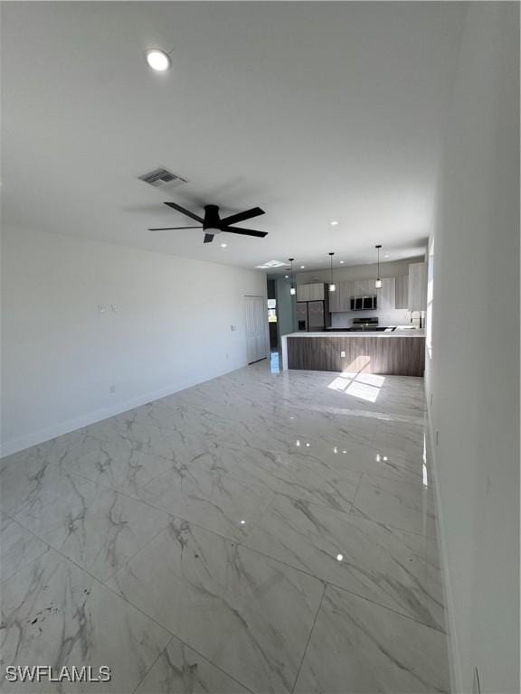 unfurnished living room with recessed lighting, visible vents, and marble finish floor