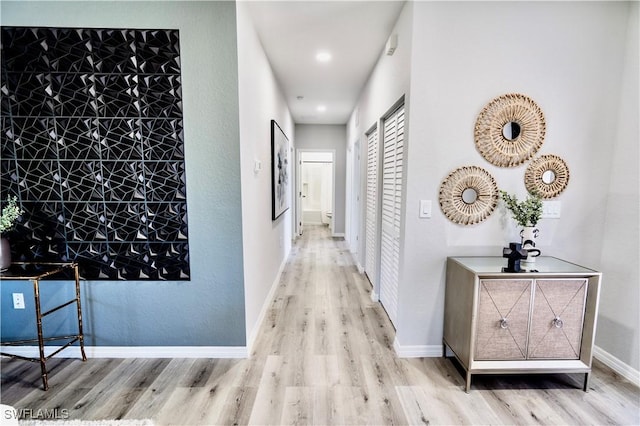 corridor with light hardwood / wood-style flooring