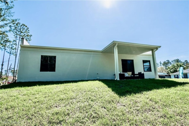 rear view of house with a yard