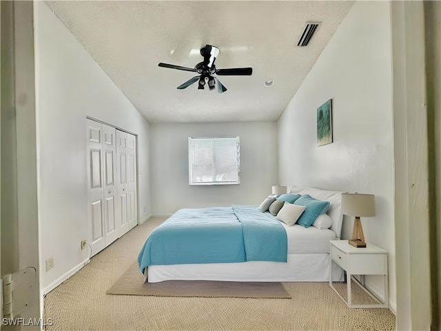 carpeted bedroom with a closet and ceiling fan