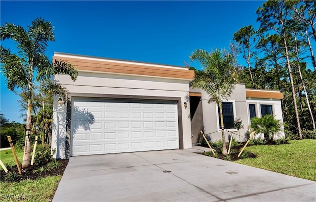 view of front of property featuring a garage and a front yard