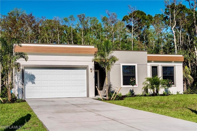 view of front of property with a garage and a front yard