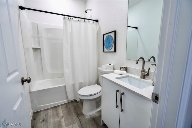 full bathroom featuring vanity, toilet, hardwood / wood-style floors, and shower / bath combo with shower curtain