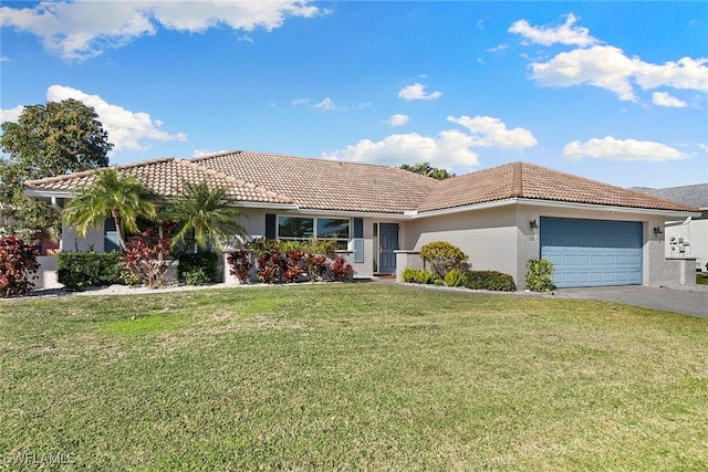 view of front of property featuring a garage and a front lawn