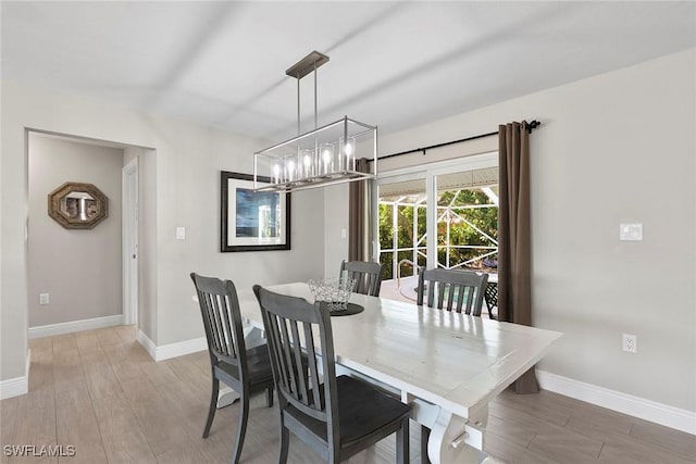 dining area with an inviting chandelier and hardwood / wood-style floors