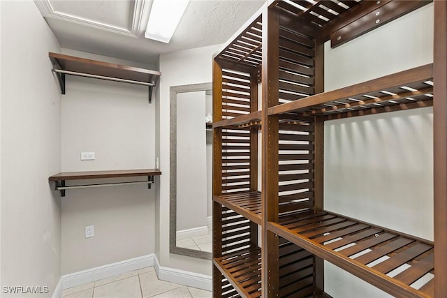 spacious closet featuring light tile patterned floors