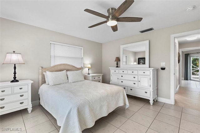 tiled bedroom featuring ceiling fan