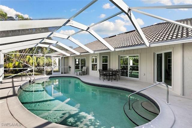 view of swimming pool featuring a lanai and a patio