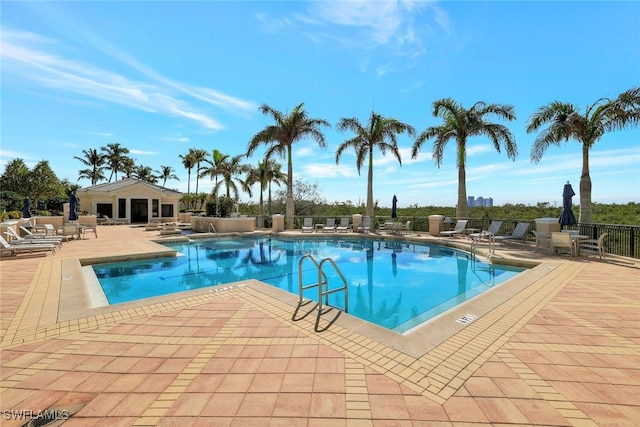 pool featuring a patio area and fence