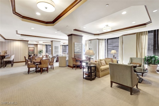 living room featuring light carpet, crown molding, a raised ceiling, and a wealth of natural light