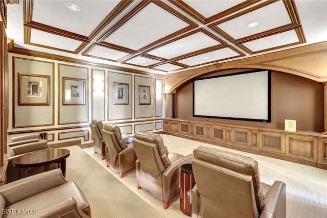 cinema featuring coffered ceiling, light colored carpet, crown molding, and a decorative wall