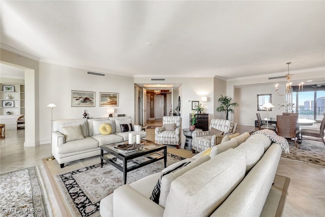 tiled living room featuring crown molding and a chandelier