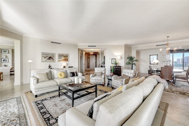 living area with visible vents, a notable chandelier, and crown molding