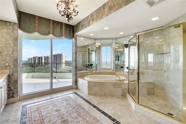 bathroom with a stall shower, visible vents, a bath, and vanity
