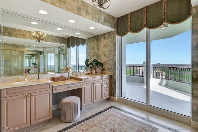 bathroom with vanity, tile patterned flooring, plenty of natural light, and a chandelier