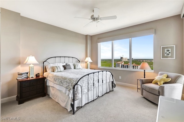 bedroom with ceiling fan and light colored carpet