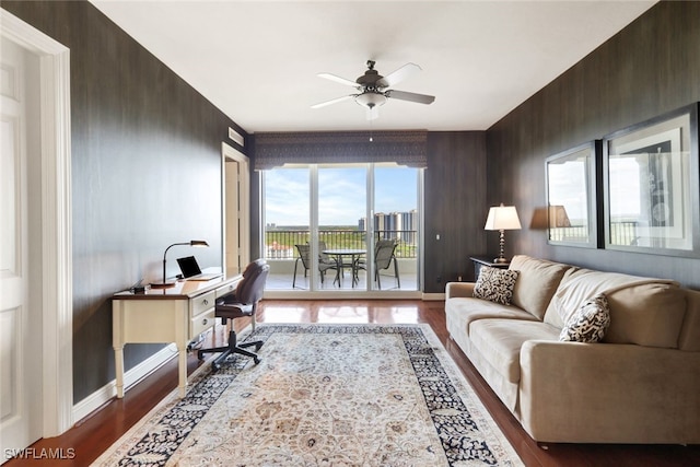 home office with baseboards, wood finished floors, and a ceiling fan