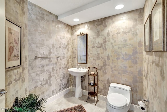 half bath with recessed lighting, toilet, and baseboards