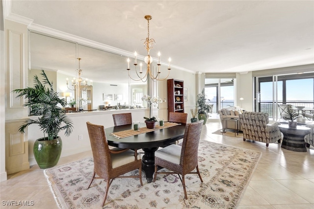 dining area featuring light tile patterned floors, crown molding, and an inviting chandelier