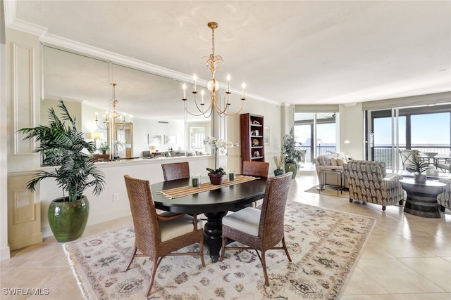 dining area with crown molding, a notable chandelier, and light tile patterned flooring