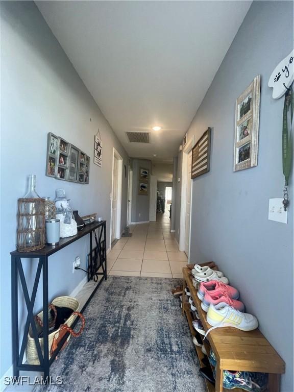 hall featuring light tile patterned floors