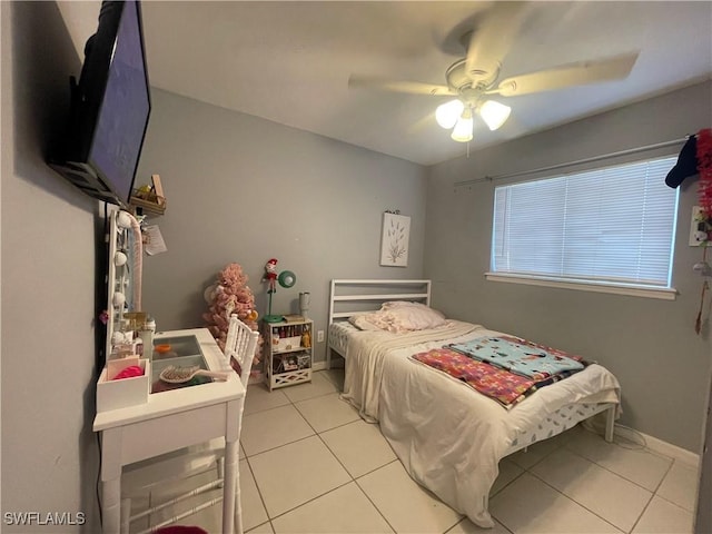 tiled bedroom featuring ceiling fan