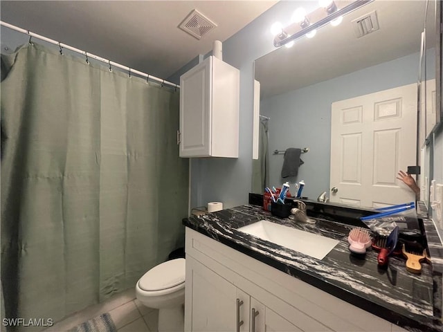 bathroom with vanity, tile patterned floors, and toilet