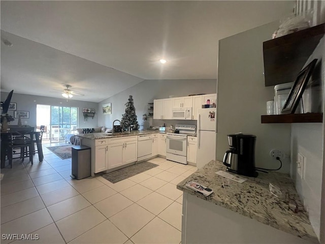 kitchen featuring sink, kitchen peninsula, white appliances, light stone countertops, and white cabinets