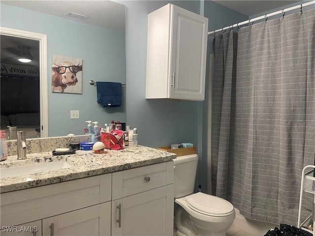 bathroom with vanity, toilet, and curtained shower