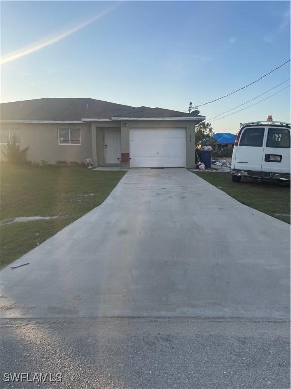 view of front of home featuring a garage and a front lawn