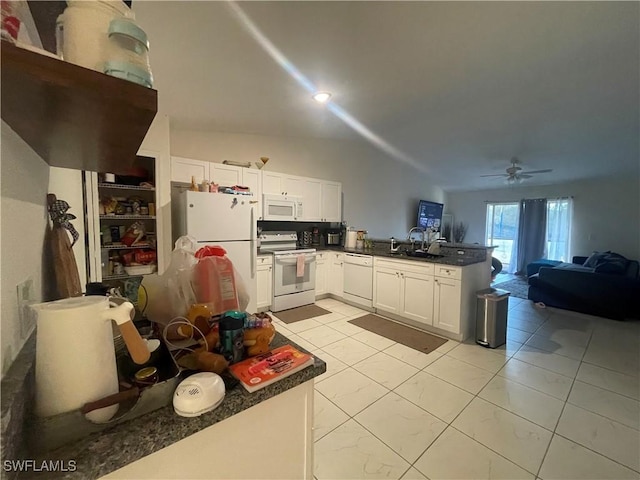 kitchen with sink, light tile patterned floors, white cabinets, and white appliances