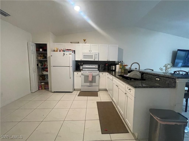 kitchen with sink, white appliances, white cabinetry, kitchen peninsula, and dark stone counters