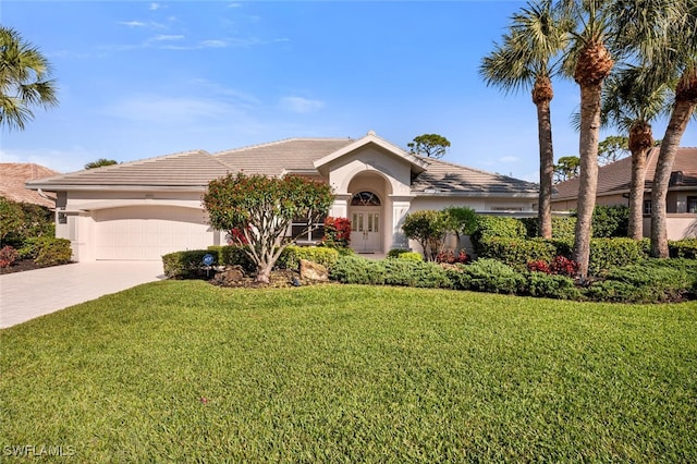 ranch-style house with a garage and a front lawn