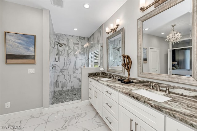 bathroom featuring a tile shower and vanity