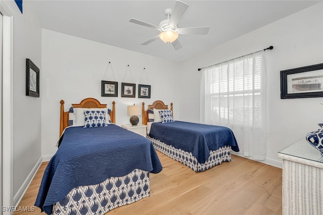 bedroom with wood-type flooring and ceiling fan