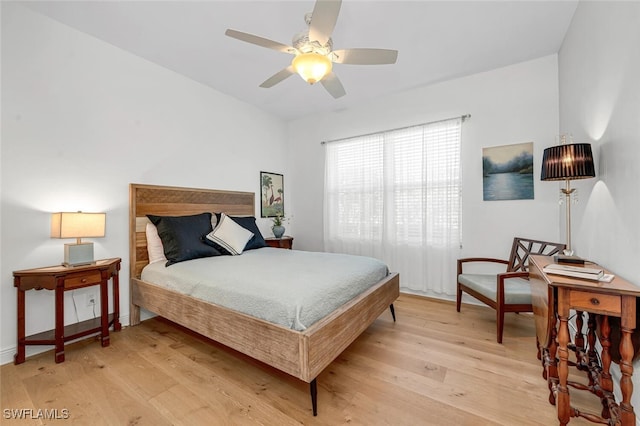 bedroom with light wood-style floors and a ceiling fan