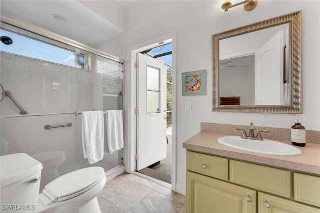 bathroom featuring vanity, an enclosed shower, and toilet